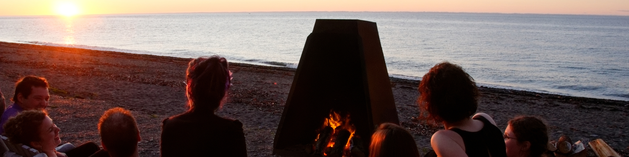 People around a bonfire, sunset