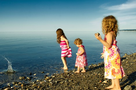 3 little girls playing in the water, on the beach