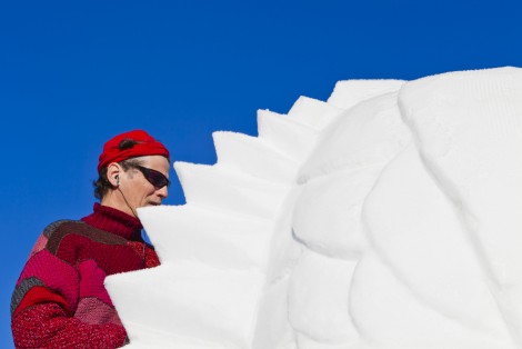 Homme faisant une sculpture sur neige